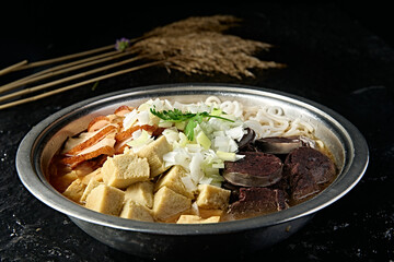 Mongolian cuisine: blood sausage, roasted pork, frozen tofu and vermicelli stew