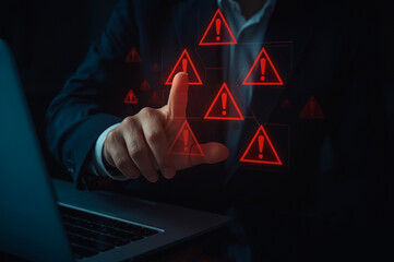 Business investment risks. Businessman use laptop with virtual stock growth graph with red warning sign for caution in investing economic situation warning, investment in economy crisis.