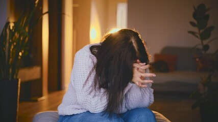 sad senior woman is nervous under stress fidget and pray, depression emotion. lonely old age lady feels bad mental health. coping with grief stress misfortune panic attack. dark room with sun light