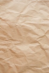Brown crumpled paper texture or background for design with copy space for text, top view. Packaging material.