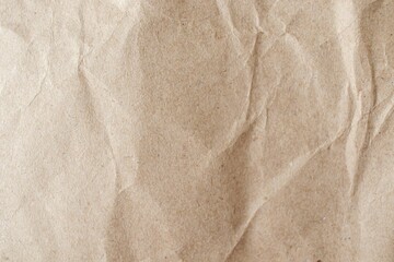 Brown crumpled paper texture or background for design with copy space for text, top view. Packaging material.