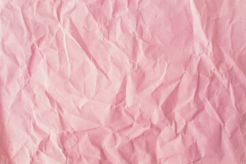 Pink crumpled paper background. Texture of crumpled paper, top view, copy space.