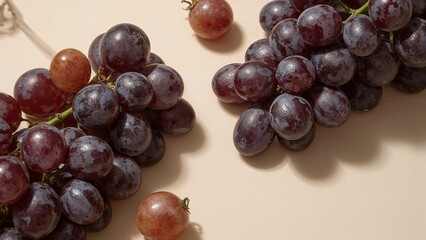 Bunches of red grapes on a light beige surface.