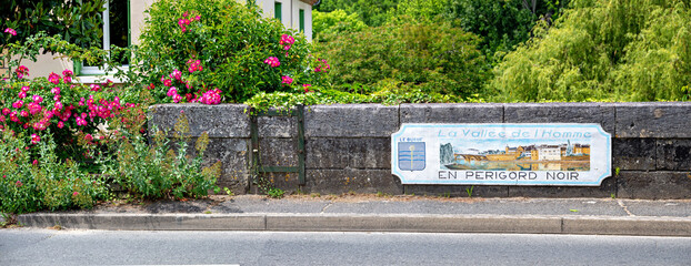 Artistically designed town sign at the entrance to the village of Le Bugue in Périgord, France. Le Bugue is the home of the well-known crime writer Martin Walker.
