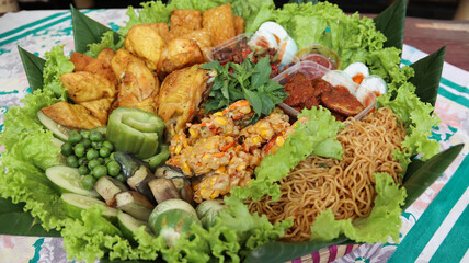 Traditional Side Dishes of yellow rice, A Staple in Indonesian Thanksgiving Ceremonies