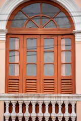 Fototapeta na wymiar Vintage Arched Window with Balcony Railing