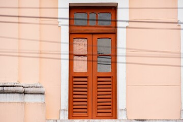 Fototapeta na wymiar Burnt orange wooden door with glass panels