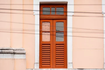  Burnt orange wooden door with glass panels © Wirestock