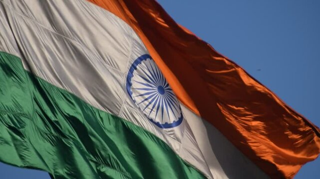 India flag flying high at Connaught Place with pride with plain white background, India flag fluttering, Indian Flag on Independence Day and Republic Day of India, tilt up shot, Har Ghar Tiranga