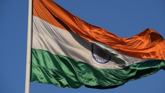 India flag flying high at Connaught Place with pride with plain white background, India flag fluttering, Indian Flag on Independence Day and Republic Day of India, tilt up shot, Har Ghar Tiranga