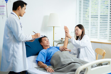 Doctor and nurse warmly support senior patient in hospital bed, discussing diagnosis & care plan.
