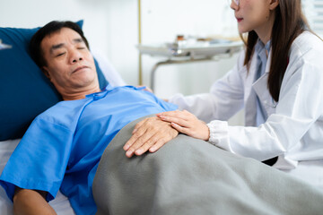 Doctor and nurse warmly support senior patient in hospital bed, discussing diagnosis & care plan.