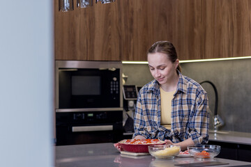 Smiling Woman in Kitchen Showing Freshly Baked Quiche Lorraine