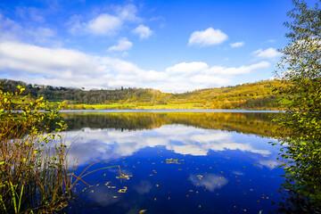 Landscape at the Schalkenmehrener Maar in autumn. View of the idyllic nature by the lake in the Eifel near the Dauner Maar.
