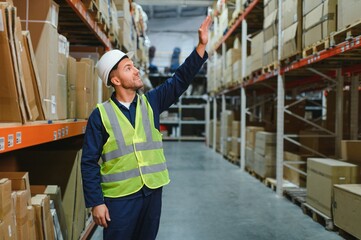 portrait of a smiling young warehouse worker working in a cash and carry wholesale store