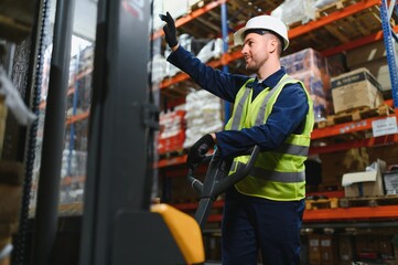 Man Driving Fork Lift Truck In Warehouse