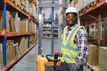 african american Storehouse manager supervising the lift truck operator