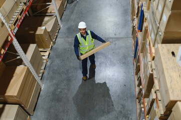 Young man working at a warehouse with boxes