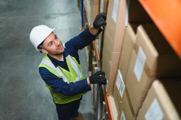 portrait of a smiling young warehouse worker working in a cash and carry wholesale store