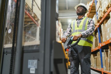 African american Man Driving Fork Lift Truck In Warehouse