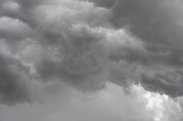 Dark, brooding storm clouds loom overhead, poised to release their downpour.