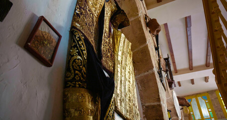 Traditional clothing with fine embroidery in the old town of Sousse. African clothes style on display on the walls.