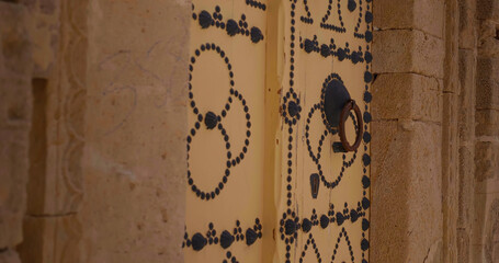 Close up architectural door in old ancient city of Sousse. Colorful textured door of muslim architecture.
