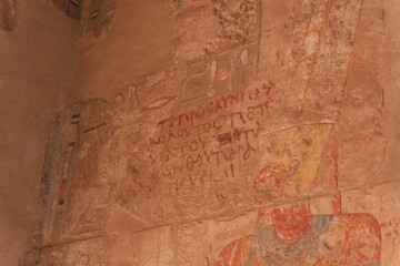 Ancient egyptian hieroglyphics and drawings covering a wall