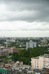 High-Rise Buildings and Dense Urban Skyline with Lush Greenery under Overcast Sky in Modern Metropolitan Cityscape