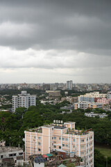 High-Rise Buildings and Dense Urban Skyline with Lush Greenery under Overcast Sky in Modern Metropolitan Cityscape