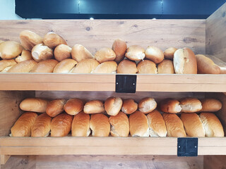Freshly tradicional baked bread on shelf in bakery shop closeup