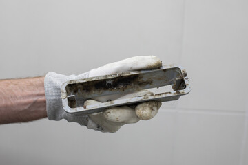 Bathroom drain with mildew and dirt in plumber hand