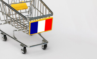 Shopping, VAT and retail in France concept. Shopping Cart with French flag on white background