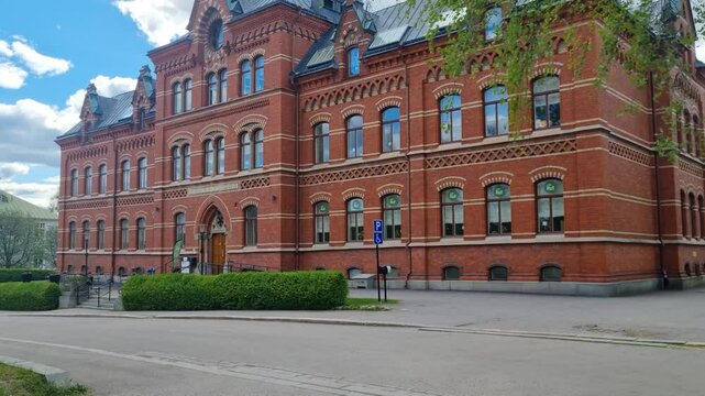 Revealing shot of Kyrkans Hus in Sundsvall, Sweden. This historic red-brick building, blending Gothic and Romanesque styles once served as a parish center