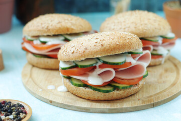 Bun sandwiches with salami and vegetables