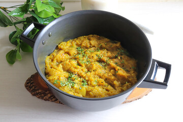 Sweet and tangy Pumpkin Oambal or chutney made with red pumpkin, jaggery, raw mango, onion seeds, garlic, chili, and curry leaves. A traditional Maharashtrian dish, perfect for a festive thali meal.
