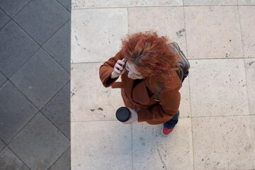 Overhead view of woman walking with coffee