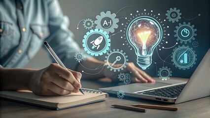 A person sits at a desk, working on a laptop with a glowing lightbulb and related symbols illustrating ideas and innovation