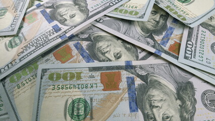 A Neatly Arranged Stack of Hundred Dollar Bills Placed on a Flat Surface for Display