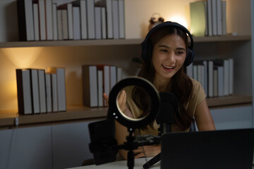 Remote Work and Digital Communication. Engaging woman in headphones conducting a virtual meeting.