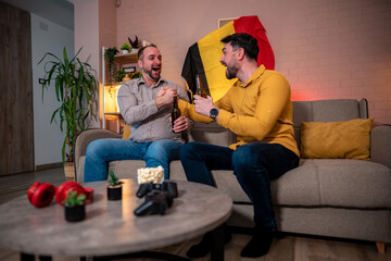 Friends enjoy drinks and games at a home evening gathering