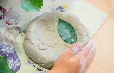 Konzept Basteln und Kreativität Kinder: Detailblick von oben auf die Hand eines Jungen, der an...