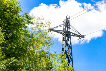 Large electricity pylon power pole with blue sky in Austria.