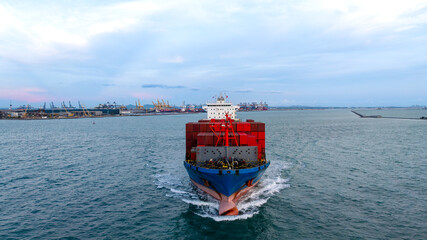 logistic cargo container ship sailing in sea to import export goods and distributing products to...