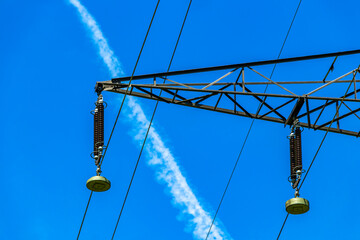 Large electricity pylon power pole with blue sky in Austria.
