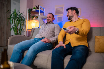 Friends enjoying movie night at home with snacks and drinks