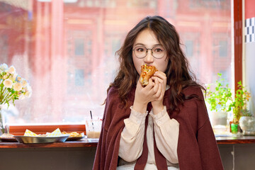 Oriental women eating a lot at the Meiyan hot dog fast food restaurant