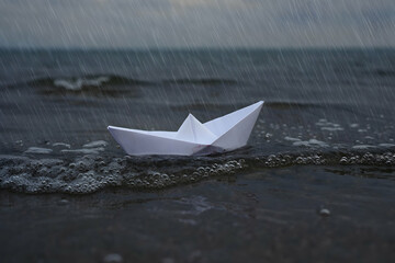 Paper Boat Floating on Water During Rainy Day