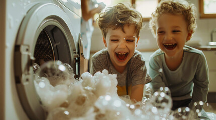 Young brothers laughing as soap overflows in a bright modern laundry room