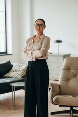 In glasses, front view. Woman in formal clothes is in the modern big room